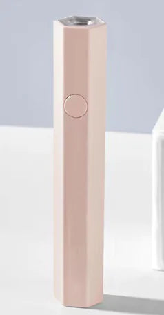 Pink compact nail lamp for travel with sleek hexagonal design and single button operation
