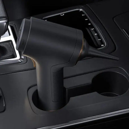 Black mini handheld vacuum powerful suction placed in car cup holder for easy cleaning