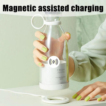 Portable juicer blender with magnetic assisted charging held by hand with green nails