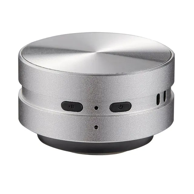 Compact silver portable conduction speaker with play and power buttons and metallic finish